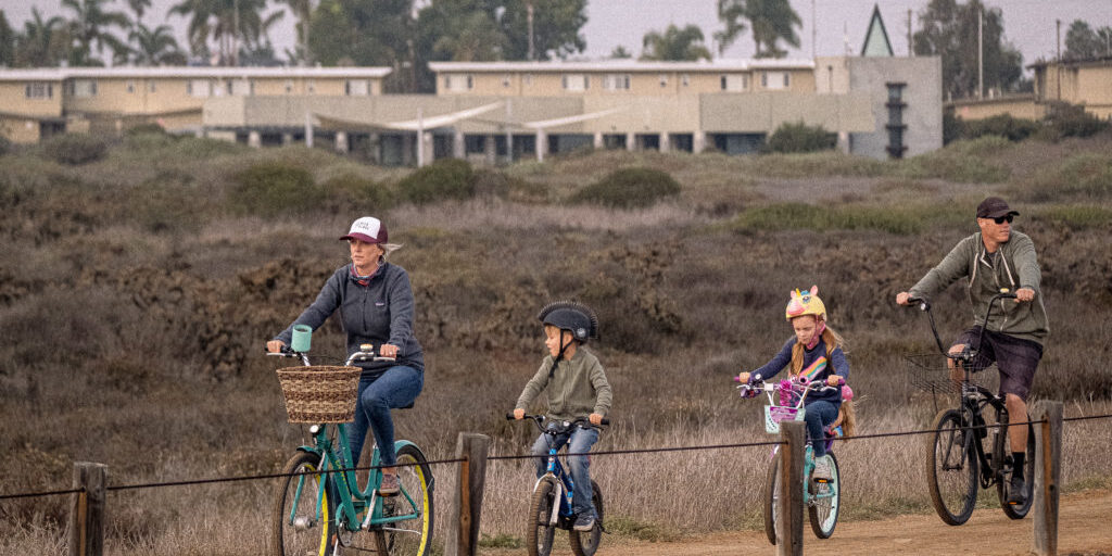 A family rides their bikes through the Tijuana Estuary