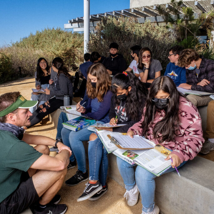 Students and instructor working on an assignment outside of the Tijuana Estuary Visitor Center