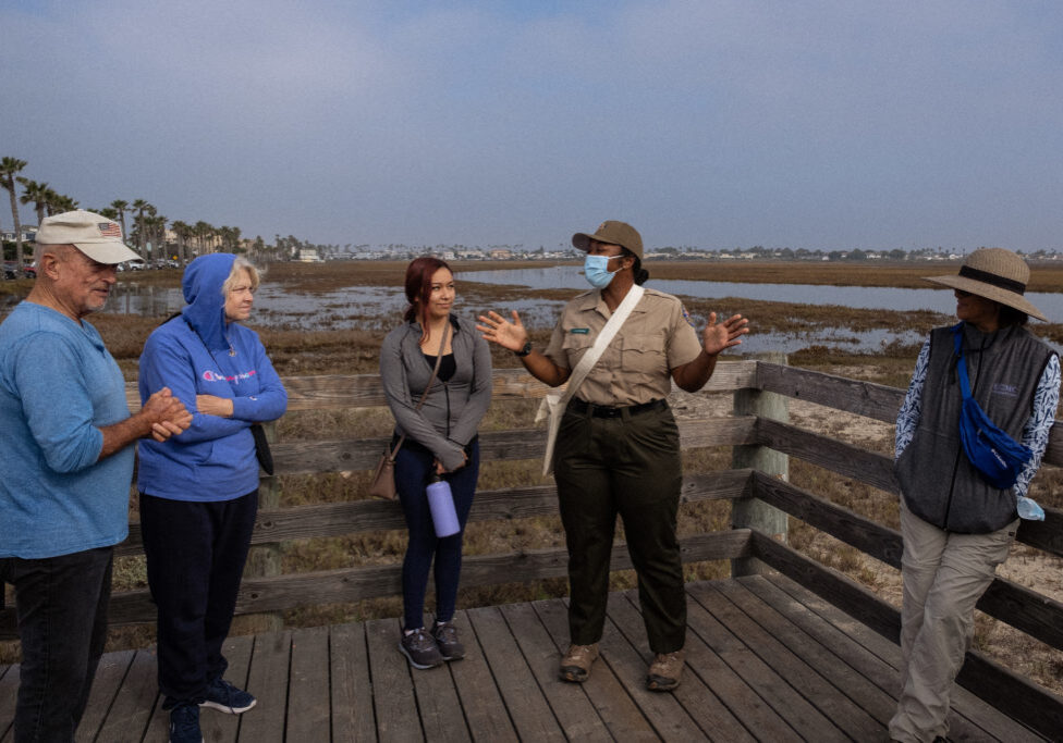 Park ranger at the Tijuana River National Estuarine Research Reserve speaking to a group of visitors
