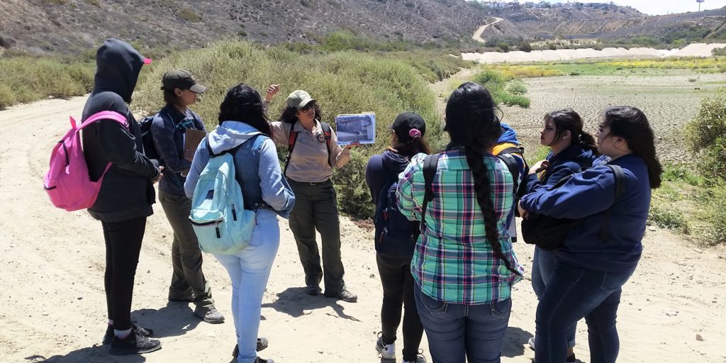 A group of students explore the Reserve and are guided by a California State Parks employee
